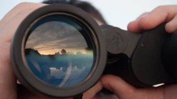 Man looking through binoculars